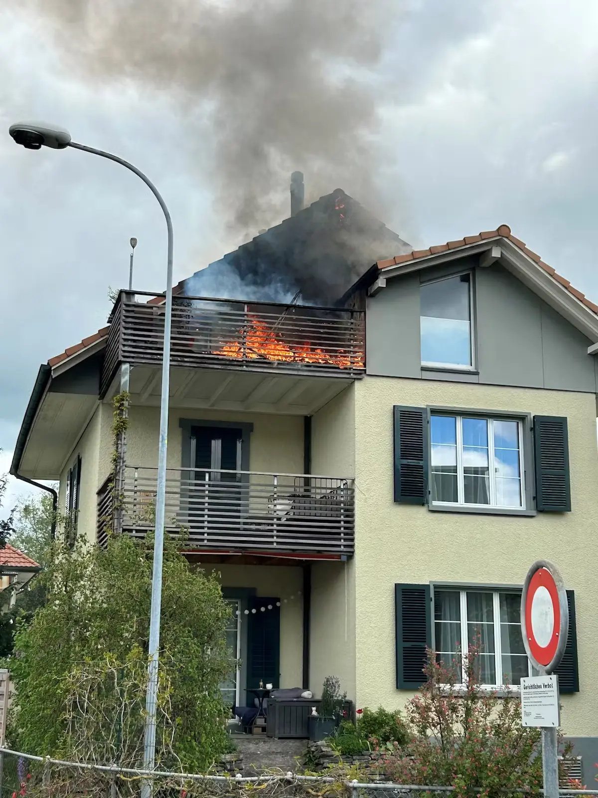 Lodernde Flammen am Dachstuhl – ein Haus steht in Brand. (Bild von Kapo BE)