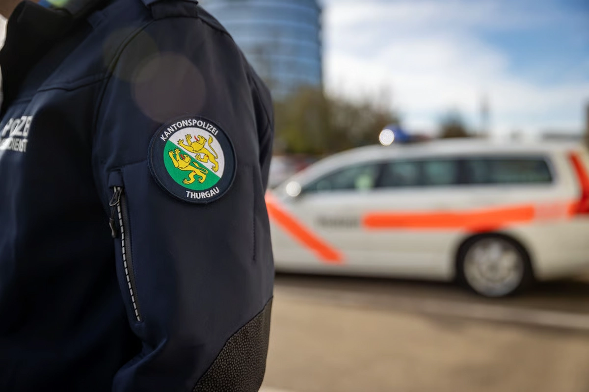 Uniformierter Polizist der Kantonspolizei Thurgau vor Einsatzfahrzeug